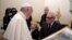 Pope Francis looks at a painting given to him as a gift from director Martin Scorsese, right, on the occasion of their private audience at the Vatican, Nov. 30, 2016.  Francis has met with Scorsese, whose new film, "Silence," about Jesuit missionaries in 17th-century Japan, was screened this week in Rome.