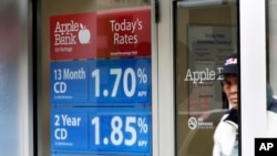 FILE - A sign in the window of the Apple Bank for Savings in New York's Financial District shows CD rates.