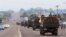FILE - Congo military trucks carrying Congolese troops drive in a main street after violence erupted due to the delay of the presidential elections in Kinshasa, Democratic Republic of the Congo, Sept. 20, 2016.