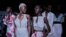 FILE - Models sit backstage during Dakar Fashion Week in the Senegalese capital, June 30, 2017.