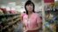 Song Un Pyol, manager at the Potonggang department store stands in the snacks aisle while being interviewed by The Associated Press in Pyongyang, North Korea, June 19, 2017. Three generations into Kim Jong Un's ruling dynasty, markets have blossomed and a consumer culture is taking root.