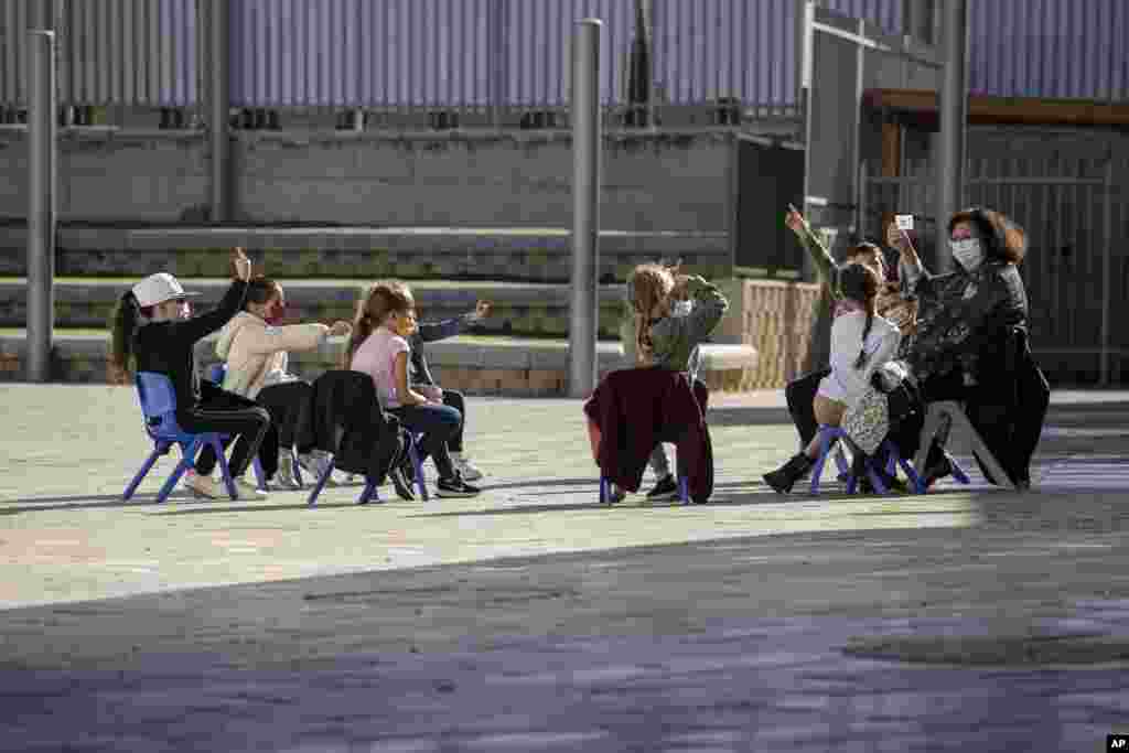 Israeli students attend class in the school yard in the costal city of Ashkelon.