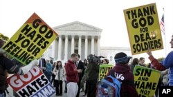 Members of the Westboro Baptist Church picket in front of the Supreme Court in Washington, 06 Oct 2010