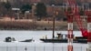 Recovery and salvage crews work near the wreckage of an American Airlines jet in the Potomac River near Ronald Reagan Washington National Airport, in Arlington, Virginia, Feb. 2, 2025.