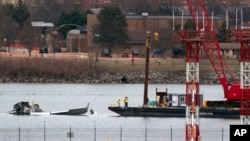 Recovery and salvage crews work near the wreckage of an American Airlines jet in the Potomac River near Ronald Reagan Washington National Airport, in Arlington, Virginia, Feb. 2, 2025.