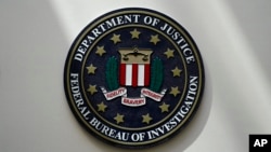 FILE - An FBI seal is seen on a wall on Aug. 10, 2022, in Omaha, Neb. Violent crime in the US dropped again in 2023, according to FBI statistics. (AP Photo/Charlie Neibergall, File)