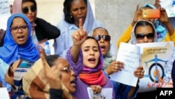 Women chant slogans during a demonstration calling for the repeal of family law in Sudan, on the occasion of International Women's Day, outside the Justice Ministry headquarters in the capital Khartoum on March 8, 2020.