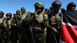Kenyan police, who are part of a UN-backed multinational force, pray on the tarmac after landing at the Toussaint Louverture International Airport in Port-au-Prince, Haiti, Feb. 6, 2025. 