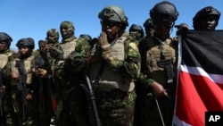 Kenyan police, who are part of a UN-backed multinational force, pray on the tarmac after landing at the Toussaint Louverture International Airport in Port-au-Prince, Haiti, Feb. 6, 2025. 