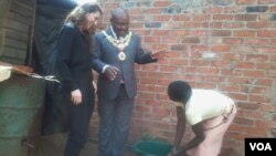 FILE: An official of the Bill and Melinda Gates Foundation and Harare mayor Bernard Manyenyeni talking to a local resident. (Photo: Irwin Chifera)