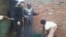 FILE: An official of the Bill and Melinda Gates Foundation and Harare mayor Bernard Manyenyeni talking to a local resident. (Photo: Irwin Chifera)