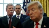 FILE PHOTO: U.S. President Donald Trump listens as his national security adviser John Bolton speaks during a presidential memorandum signing for the "Women's Global Development and Prosperity" initiative in the Oval Office at the White House in…