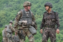 US Lt. Col. Douglas Hayes and Republic of Korea Army Col. Seong Ik Sung discuss the progress of a coordinated, joint artillery exercise May 10, 2016. (US Army photo)