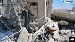 A Syrian man checks his destroyed house that was damaged by a Syrian forces air strike in the town of Qusair.