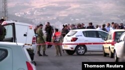 Members of Israeli forces gather at the scene of a shooting incident in the Israeli-occupied West Bank, May 5, 2021.