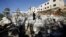 Parents of Palestinian Mohanad Al-Halabi inspect their house after it was demolished by Israeli troops in the village of Surda, near the West Bank city of Ramallah, Jan. 9, 2016. 