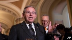 FILE - Sen. Bob Menendez, D-N.J., with then-Senate Minority Leader Chuck Schumer, D-N.Y., talks to reporters in Washington, June 12, 2018. Menendez said Oct. 10, 2022, that oil exporters' move to cut their production target was tantamount to underwriting Russia’s war in Ukraine.