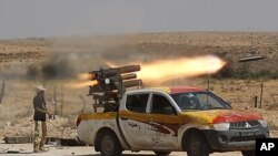 An anti-Gaddafi fighter fires a multiple-rocket launcher near Sirte, the hometown of deposed leader Moammar Gaddafi, September 17, 2011.