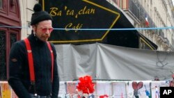 Jesse Hughes of the band Eagles of Death Metal — the band that was playing at the Bataclan concert hall in Paris at the time of the Nov. 13 bombings — pays his respects outside the hall to the 89 victims who died in the attack, Dec. 8, 2015.