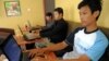 FILE - Cambodian men use the internet at a cofee shop in Phnom Penh.