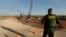 A U.S. Border Patrol agent stands over a construction site for a new section of levee border wall along the U.S.-Mexico border, Nov. 7, 2019, in Donna, Texas. 