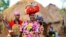 Women from Bunia in eastern Democratic Republic of Congo walk within the Kyangwali refugee settlement in Hoima district in Western Uganda, March 25, 2014. 