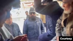 This screen grab from mobile phone video shot on Jan. 5, 2025, by Zalmay Atiq shows Pakistani police officers loading Afghan nationals into a van to be taken to a police station in Islamabad for document verification. 