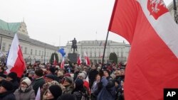 Protesters attend an anti-government demonstration, in Warsaw, Poland, Saturday, Dec. 17, 2016. 