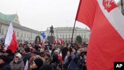 FILE - Protesters attend an anti-government demonstration, in Warsaw, Poland, Dec. 17, 2016. 