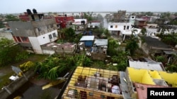 Houses without roofs are seen after Hurricane Grace slammed into the coast with torrential rains, in Costa Esmeralda, near Tecolutla, Mexico, Aug. 21, 2021.