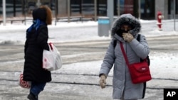 Pedestrians brave frigid sub-zero temperatures.