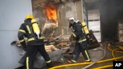 Firefighters tackle a blaze at the site of a Russian attack in Kharkiv, Ukraine, on March 20, 2024.