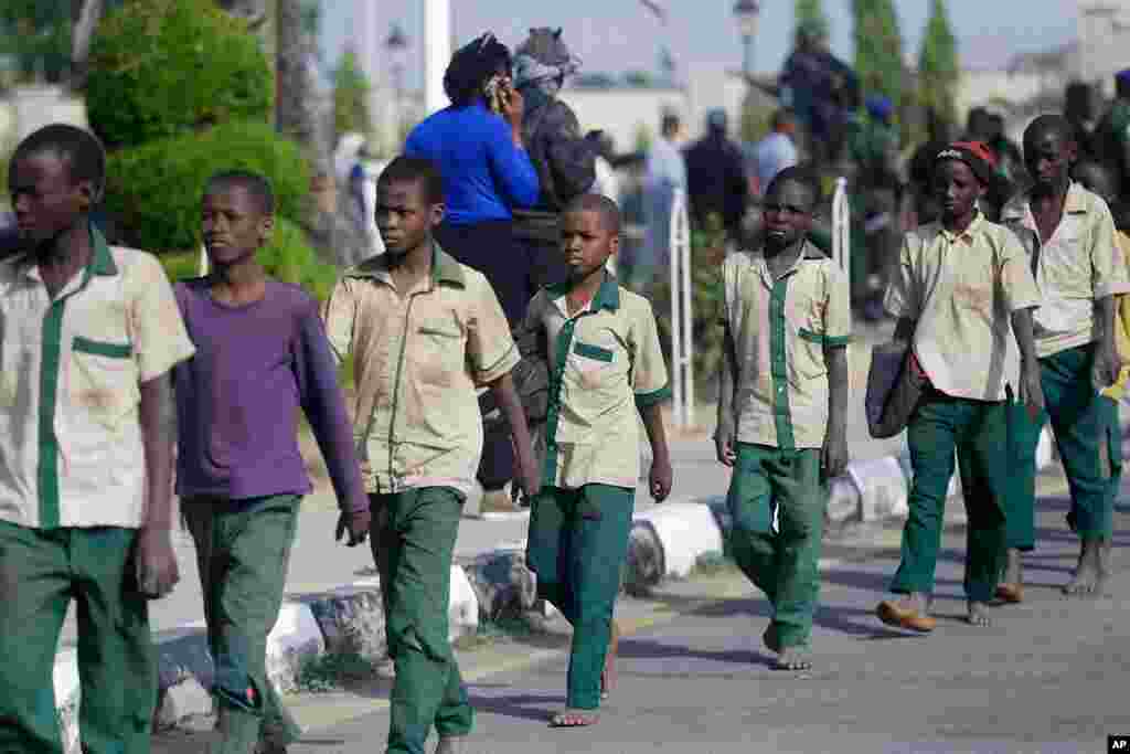 A group of schoolboys is escorted by Nigerian military and officials following their release after they were kidnapped last week, in Katsina, Nigeria.