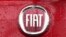 FILE - In this Jan. 2, 2014 file photo, a Fiat logo pictured on a car in Milan, Italy. Italian-American carmaker Fiat Chrysler Automobiles on Oct. 30, 2019, confirmed that it is in talks with French rival PSA Peugeot.