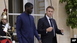 FILE - Senegalese President Bassirou Diomaye Faye and French President Emmanuel Macron leave the Elysee Palace after a lunch in Paris on June 20, 2024. Senegal is one of several African nations that have asked France to withdraw its troops from their territory.