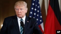 President Donald Trump listens to a question during a joint news conference with German Chancellor Angela Merkel in the East Room of the White House in Washington, March 17, 2017.