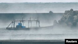 FILE - A wooden boat is seen off the coast Yurihonjo, Akita Prefecture, Japan, Nov. 24, 2017. A similar vessel was spotted Thursday off the northern Japanese island of Hokkaido.