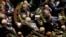 Poland's opposition lawmakers and senators with white roses, the symbol of their protest against the government policies, during a speech by President Andrzej Duda in parliament in Warsaw, Poland, Dec. 5, 2017. 