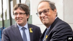 Former Catalan leader Carles Puigdemont, left, and current regional president of Catalonia Quim Torra before a meeting with government ministers and ministers in exile at the Government Delegation of Catalonia to the European Union in Brussels, July 28, 2