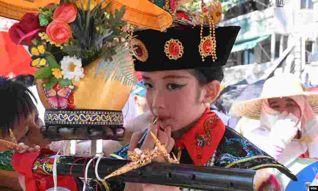 扮演清朝皇后的小女孩在巡遊時補妝。(美國之音湯惠芸拍攝)