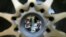 Lotus mechanics, seen through a wheel, talk to one another at the garage of the Marina Bay City Circuit in Singapore. The Formula One Singapore Grand Prix will be held on Sept. 22 in the city-state.