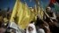 Palestinians wave national and yellow Fatah movement flags during a rally marking the 13th anniversary of the death of Fatah founder and Palestinian Authority leader Yasser Arafat, in Gaza City, Saturday, Nov. 11, 2017.