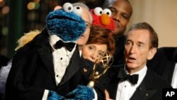 FILE - Bob McGrath, right, looks at the Cookie Monster as they accept the Lifetime Achievement Award for '"Sesame Street" at the Daytime Emmy Awards on Aug. 30, 2009, in Los Angeles.