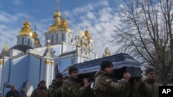 Soldiers carry the coffin of Polish volunteer soldier Filip Antosiak,18, who served in the Ukrainian army and was killed in the Russia-Ukraine war, during a ceremony in Kyiv, Ukraine, Jan. 30, 2025. 