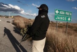 Chihuahua state police officers man a checkpoint in Janos, Chihuahua state, northern Mexico, Nov. 5, 2019. Drug cartel gunmen ambushed three SUVs along a dirt road, slaughtering six children and three women, all U.S. citizens living in Mexico.…