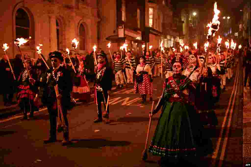 Revelers carry torches through the streets of Lewes, in east Sussex, southern England, Nov. 5, 2024, during the traditional Bonfire Night celebrations.