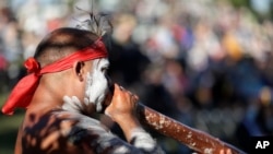 FILE - Russell Dawson of the Koomurri Aboriginal Dancers participates in a smoking ceremony during Australia Day ceremonies in Sydney, Jan. 26, 2021.