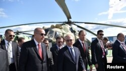 FILE - Russian President Vladimir Putin and his Turkish counterpart Recep Tayyip Erdogan visit the MAKS 2019 air show in Zhukovsky, outside Moscow, Russia, Aug. 27, 2019. 