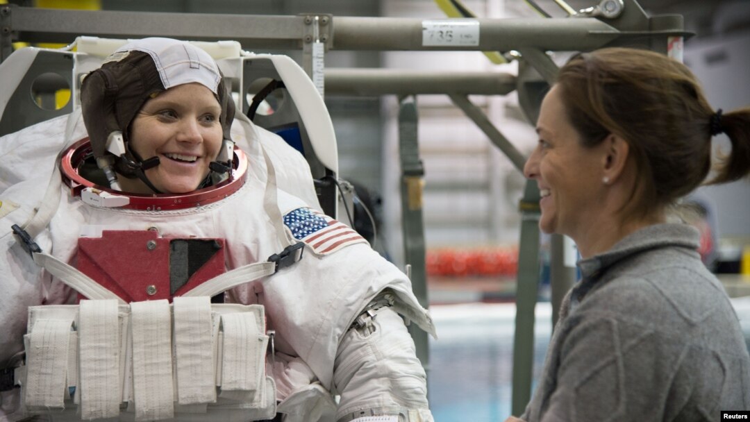 FILE - Astronaut Anne McClain, left, is seen during training at the Neutral Buoyancy Laboratory in Houston, Texas, Jan. 12, 2015. 