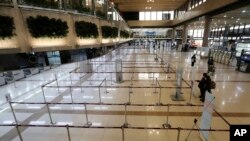 Check-in counters of Japanese airlines are deserted at Gimpo Airport in Seoul, South Korea, Saturday, March 7, 2020. 
